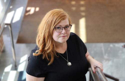 Professor standing at foot of stairs