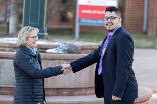 Student Henry and Chancellor Colón Rodríguez switch places