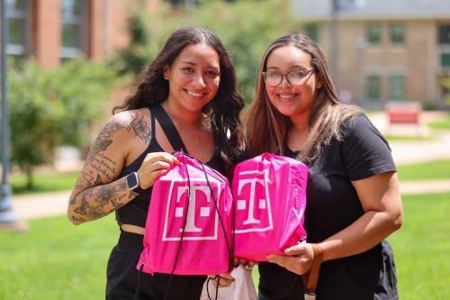 Two students with T-Mobile bags