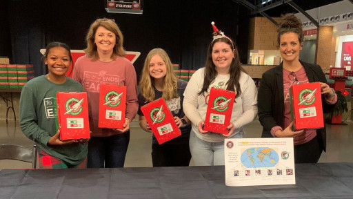 Club advisors and members with shoeboxes
