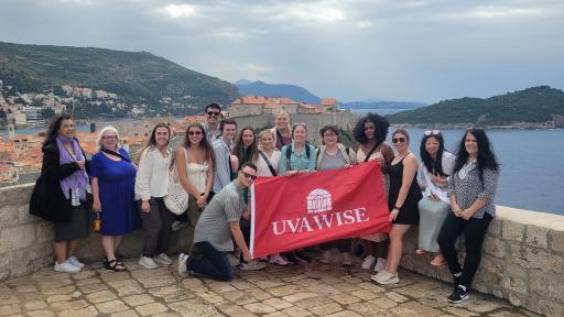 Group of students and faculty with UVA Wise flag