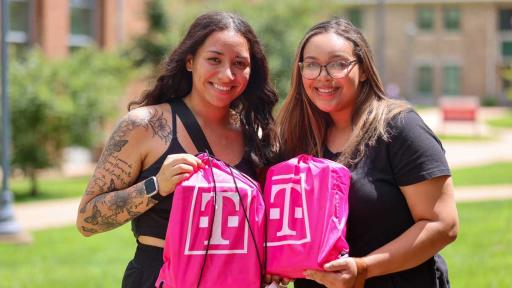 Two students with T-Mobile bags
