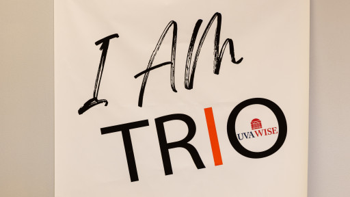 a poster on wall that says I am TRIO with the UVA Wise logo inside letter O